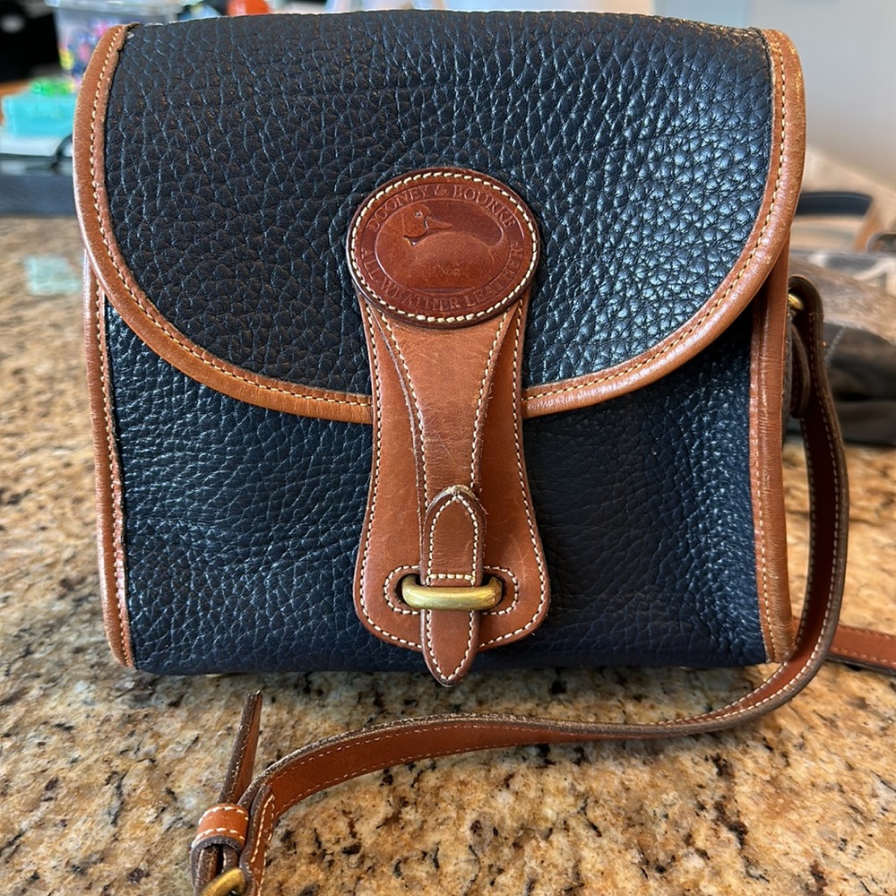 Navy blue and cognac leather Dooney and Bourke bag. Excellent vintage condition.